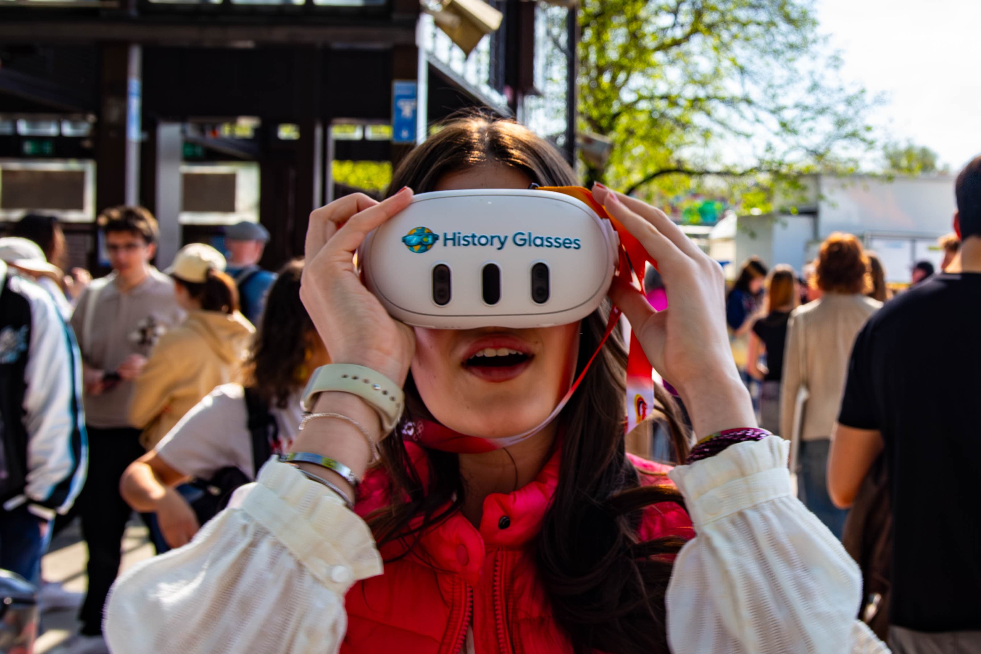 Guest on a walking tour looking thruogh See Reality History Glasses