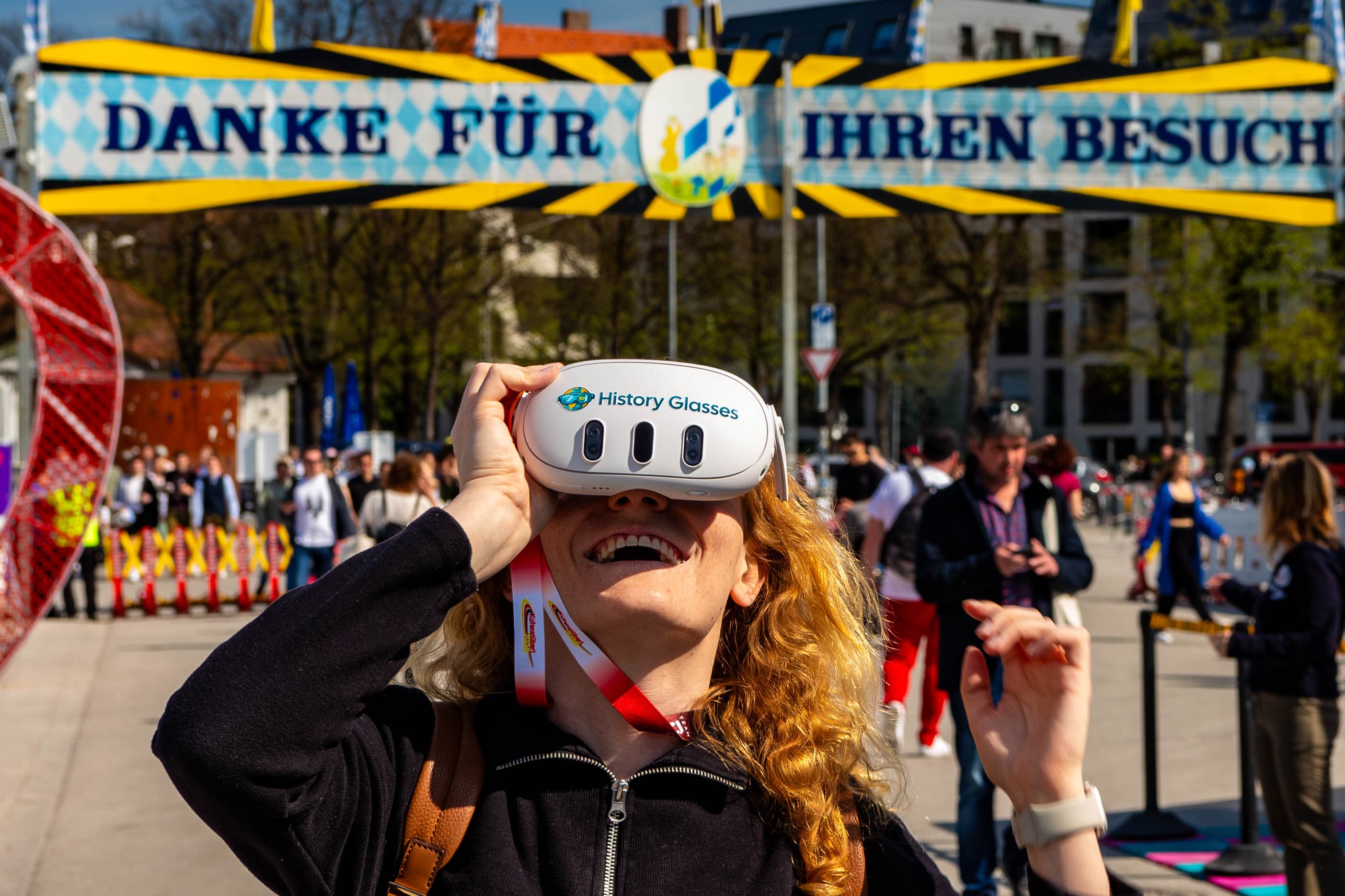 Guest at a festival looking through See Reality History Glasses